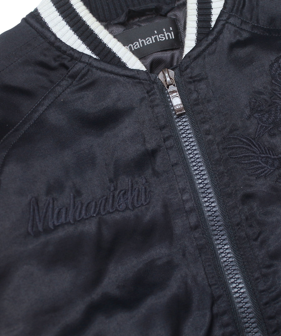 MAHARISHI Tour Jacket B22MH5220 features signature embroidery on a classic souvenir silhouette, blending military style with sustainable design.