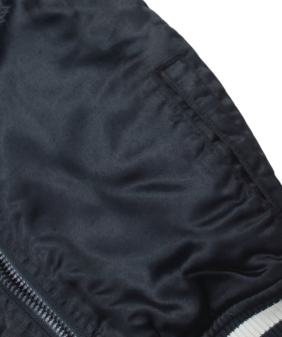 MAHARISHI Tour Jacket B22MH5220 features signature embroidery on a classic souvenir silhouette, blending military style with sustainable design.
