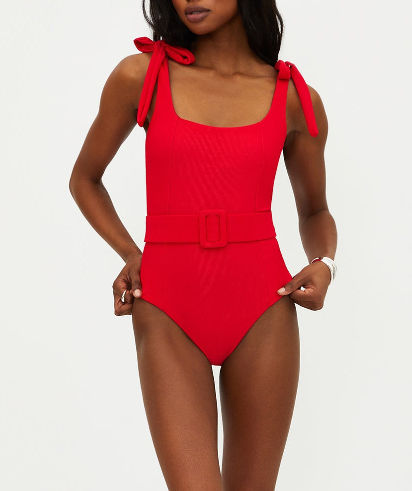 Vibrant red ribbed swimsuit featuring tie shoulder straps, removable cups, shelf bra, and optional belt. Provides a stylish, comfy fit with moderate coverage.