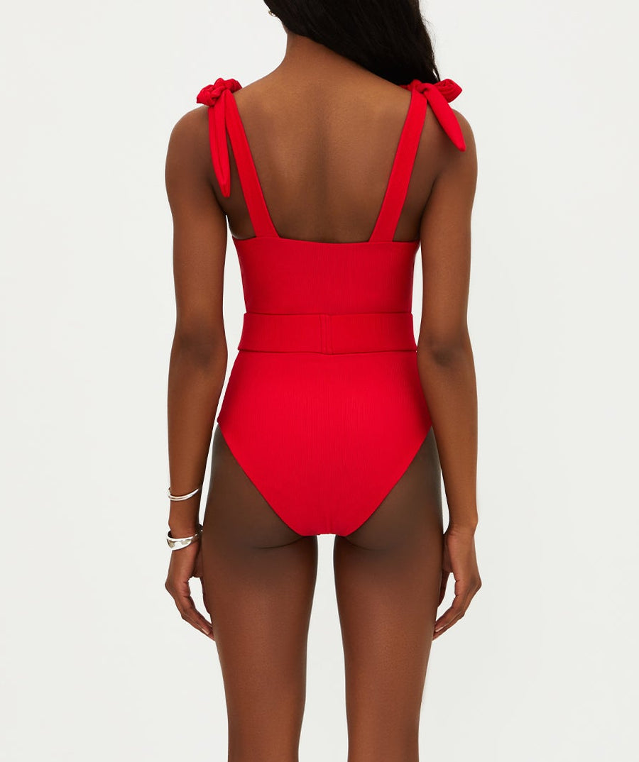 Vibrant red ribbed swimsuit featuring tie shoulder straps, removable cups, shelf bra, and optional belt. Provides a stylish, comfy fit with moderate coverage.