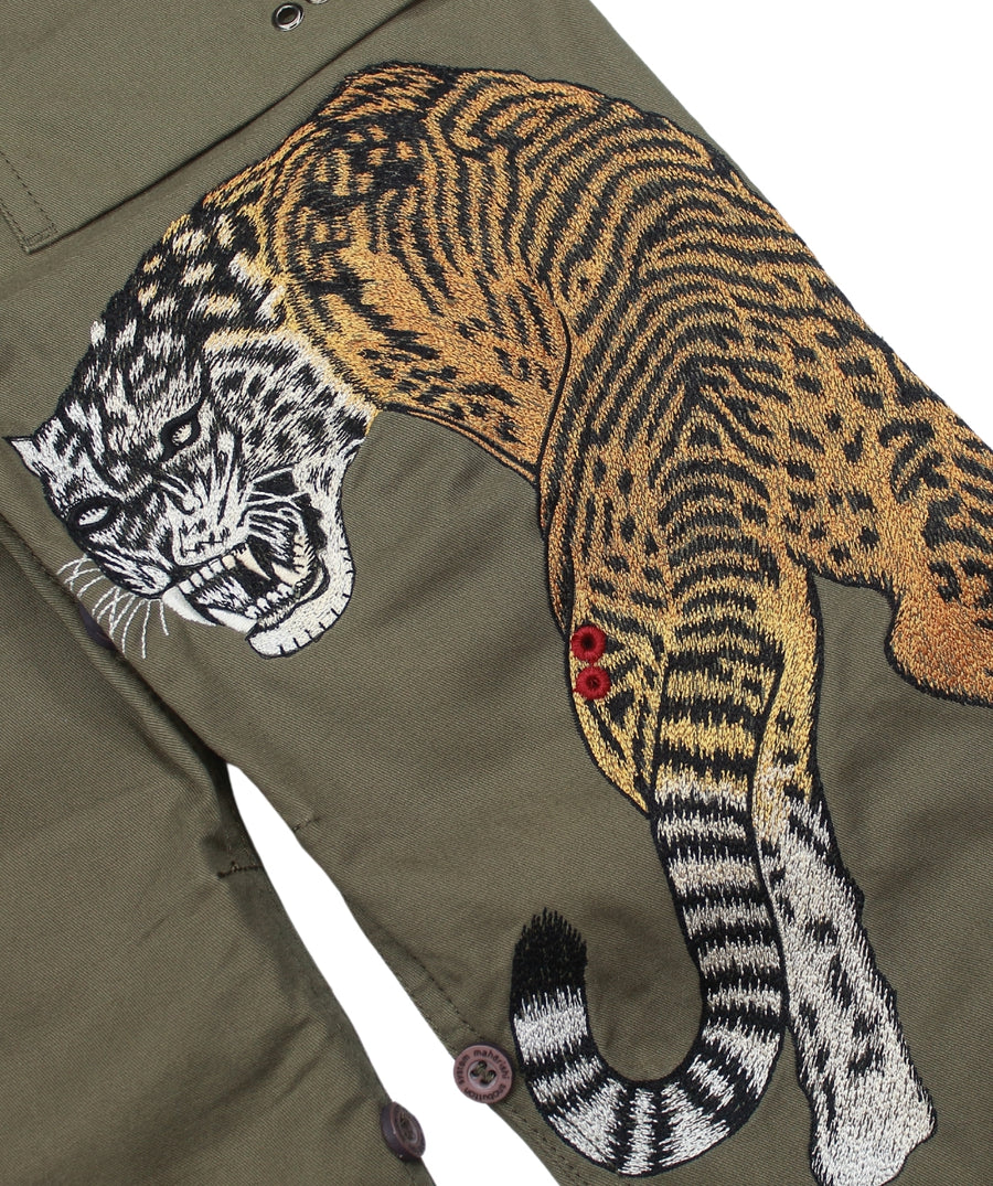 The Maharishi Kid's Tiger Snopants 5508 feature bold tiger embroidery, adjustable waistband, and durable fabric—perfect for stylish, everyday adventure.