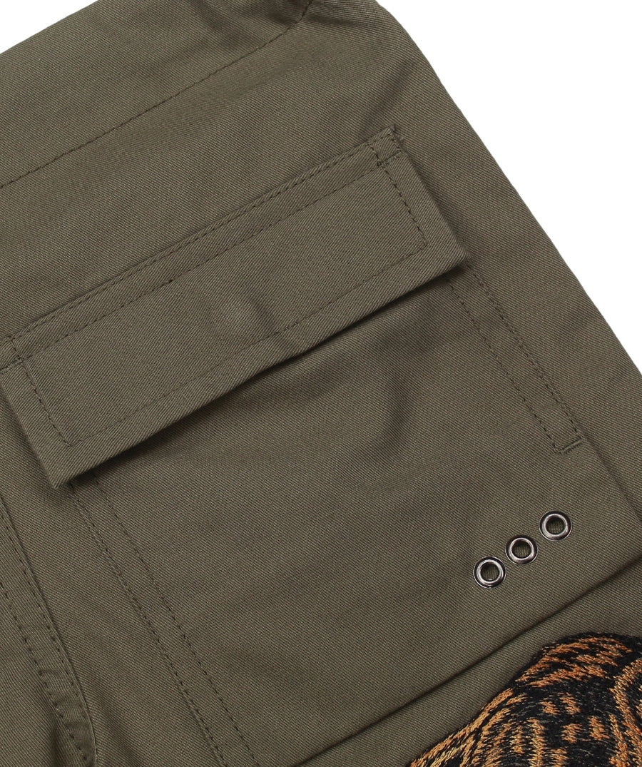 The Maharishi Kid's Tiger Snopants 5508 feature bold tiger embroidery, adjustable waistband, and durable fabric—perfect for stylish, everyday adventure.
