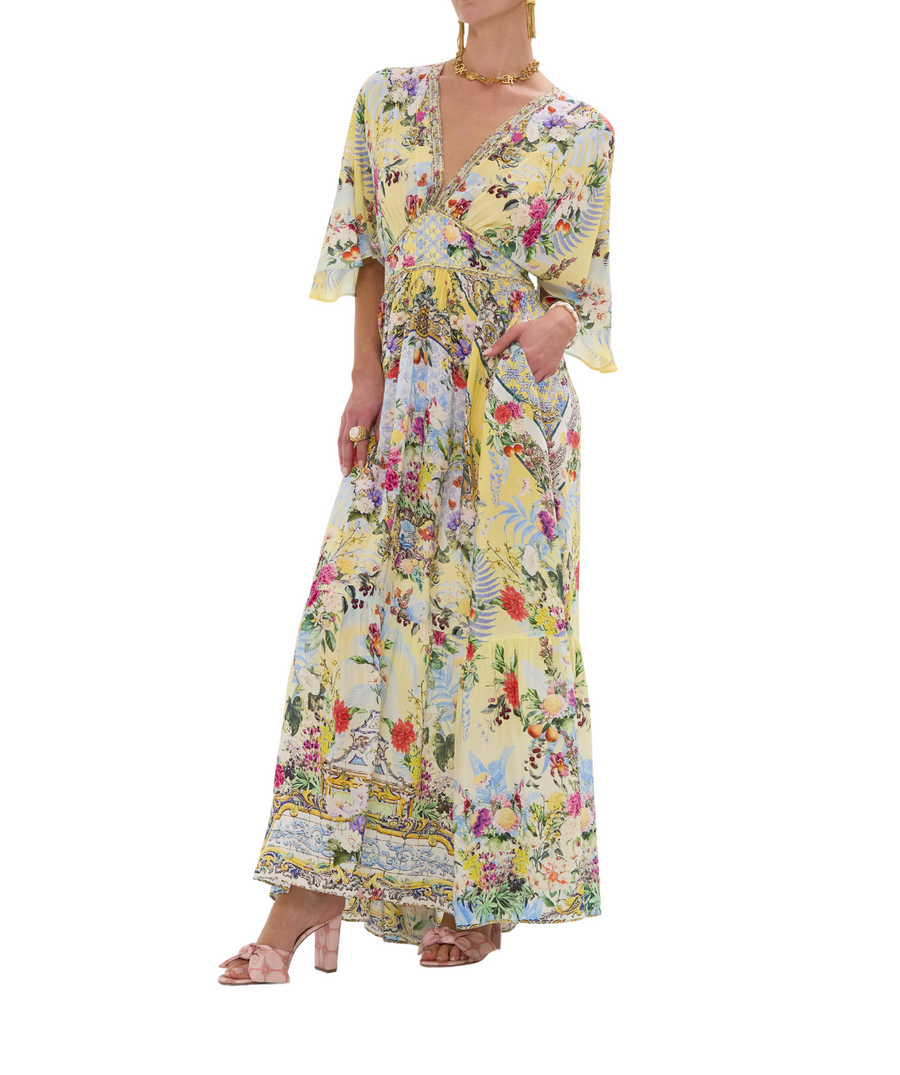 CAMILLA Flor Fantástica Long Dress 00033221 – A luxurious long dress adorned with the bold Flor Fantástica print, detailed embellishments, and a flowing silhouette.