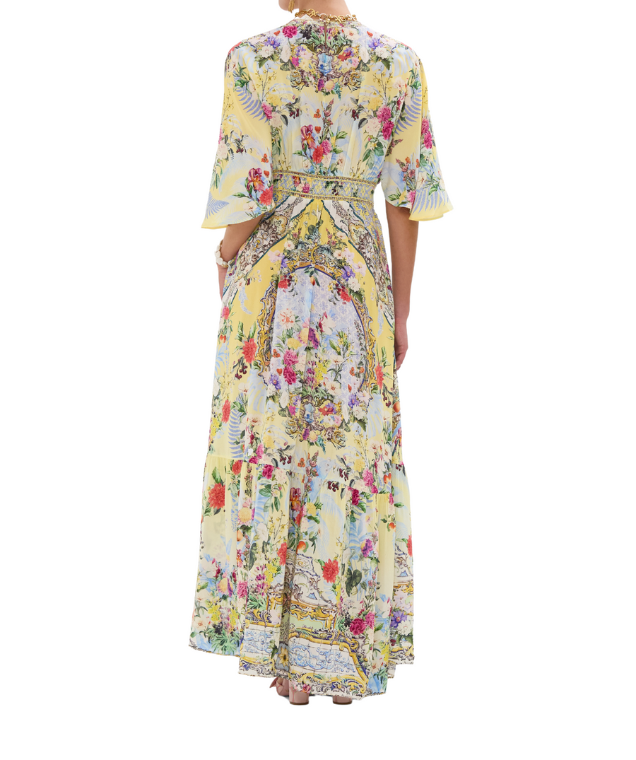 CAMILLA Flor Fantástica Long Dress 00033221 – A luxurious long dress adorned with the bold Flor Fantástica print, detailed embellishments, and a flowing silhouette.