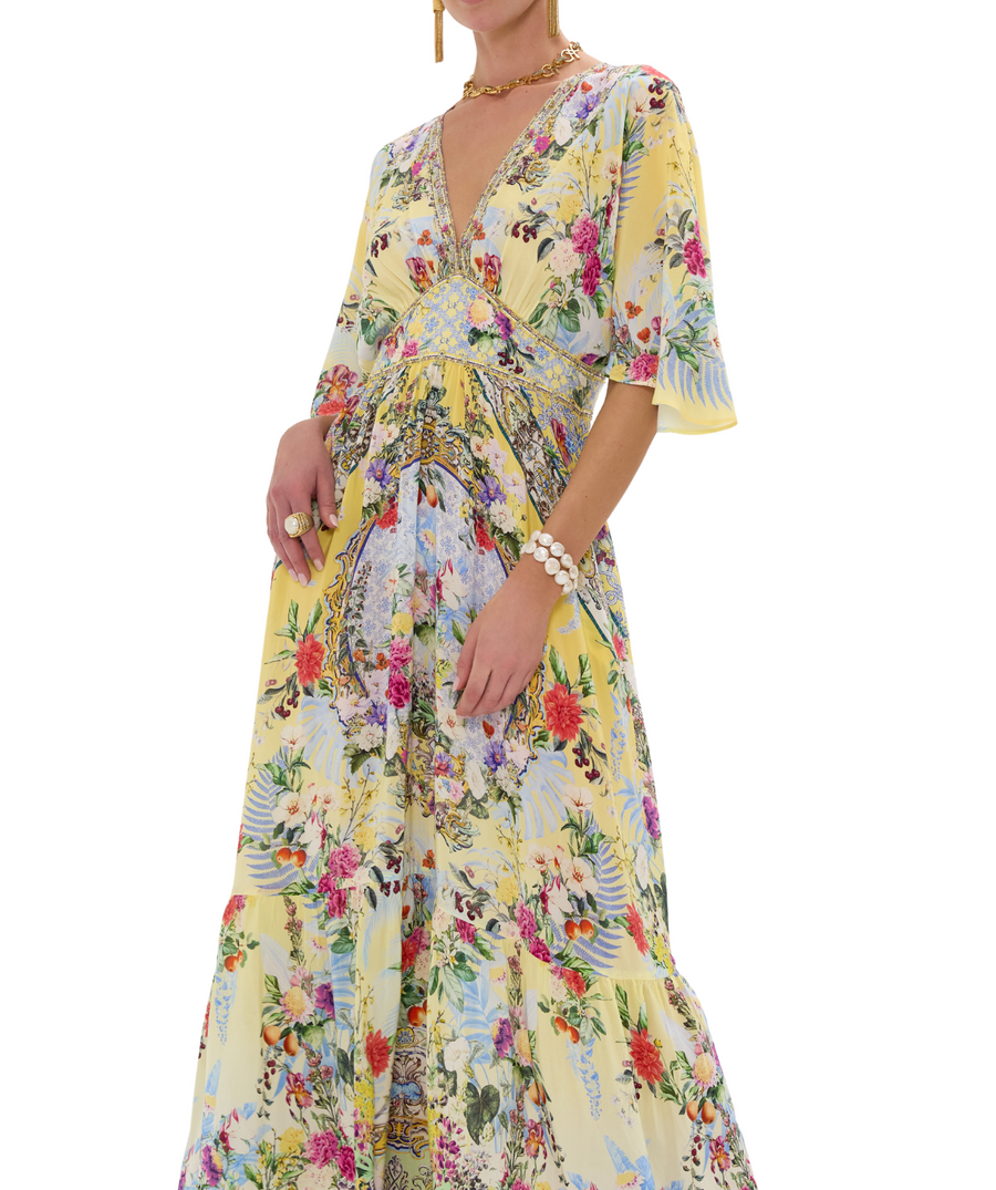 CAMILLA Flor Fantástica Long Dress 00033221 – A luxurious long dress adorned with the bold Flor Fantástica print, detailed embellishments, and a flowing silhouette.