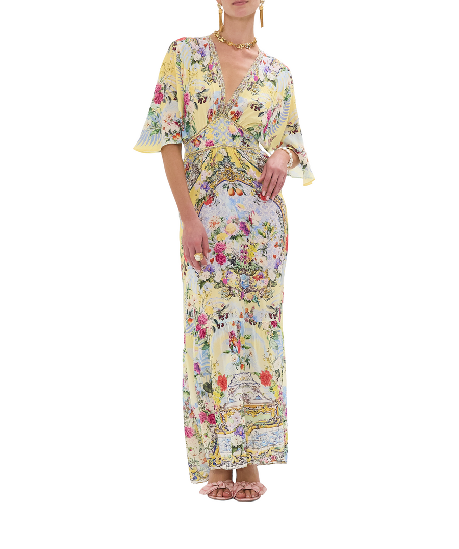 CAMILLA Flor Fantástica Long Dress 00033221 – A luxurious long dress adorned with the bold Flor Fantástica print, detailed embellishments, and a flowing silhouette.