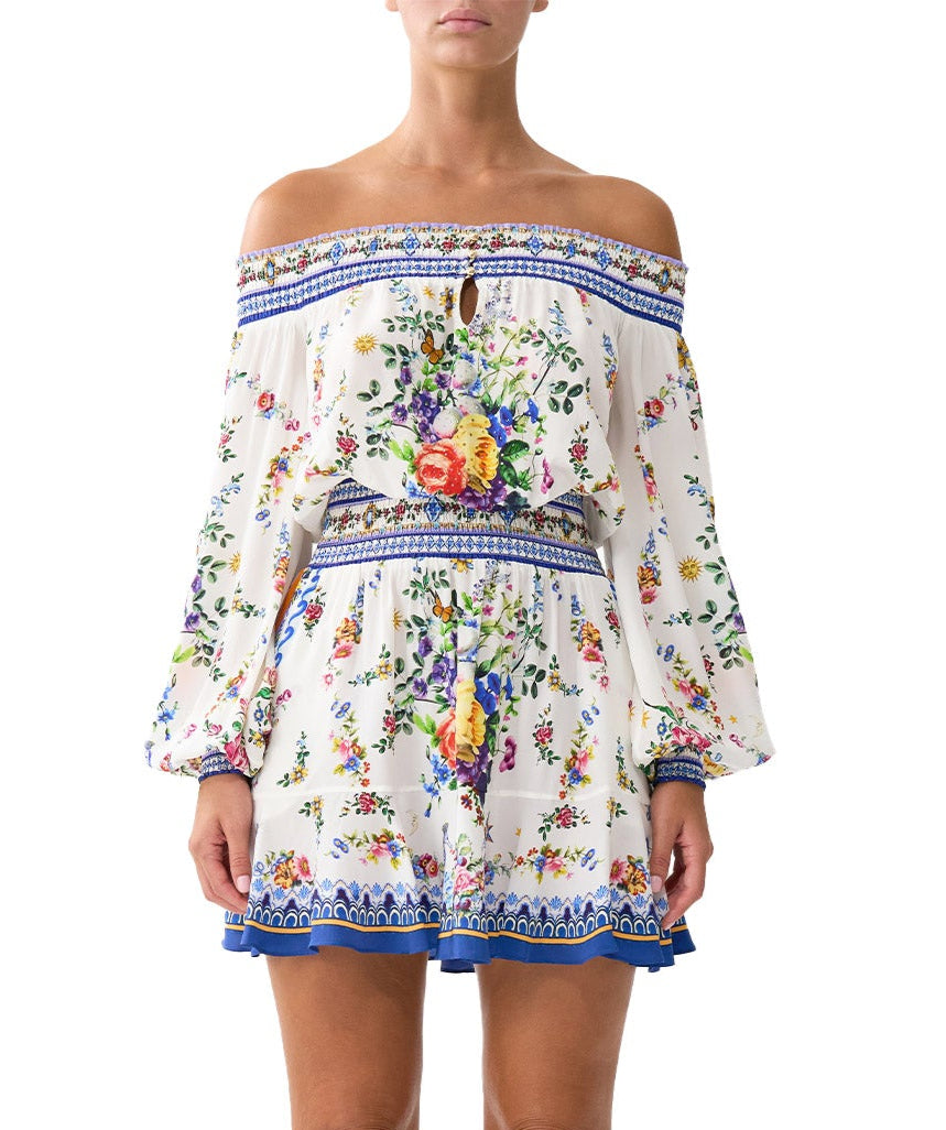 Chic and playful, the CAMILLA Tiles Darls Off Shoulder Short Dress 00035220 features bold prints and flirty ruffles—perfect for sunny days and summer nights.