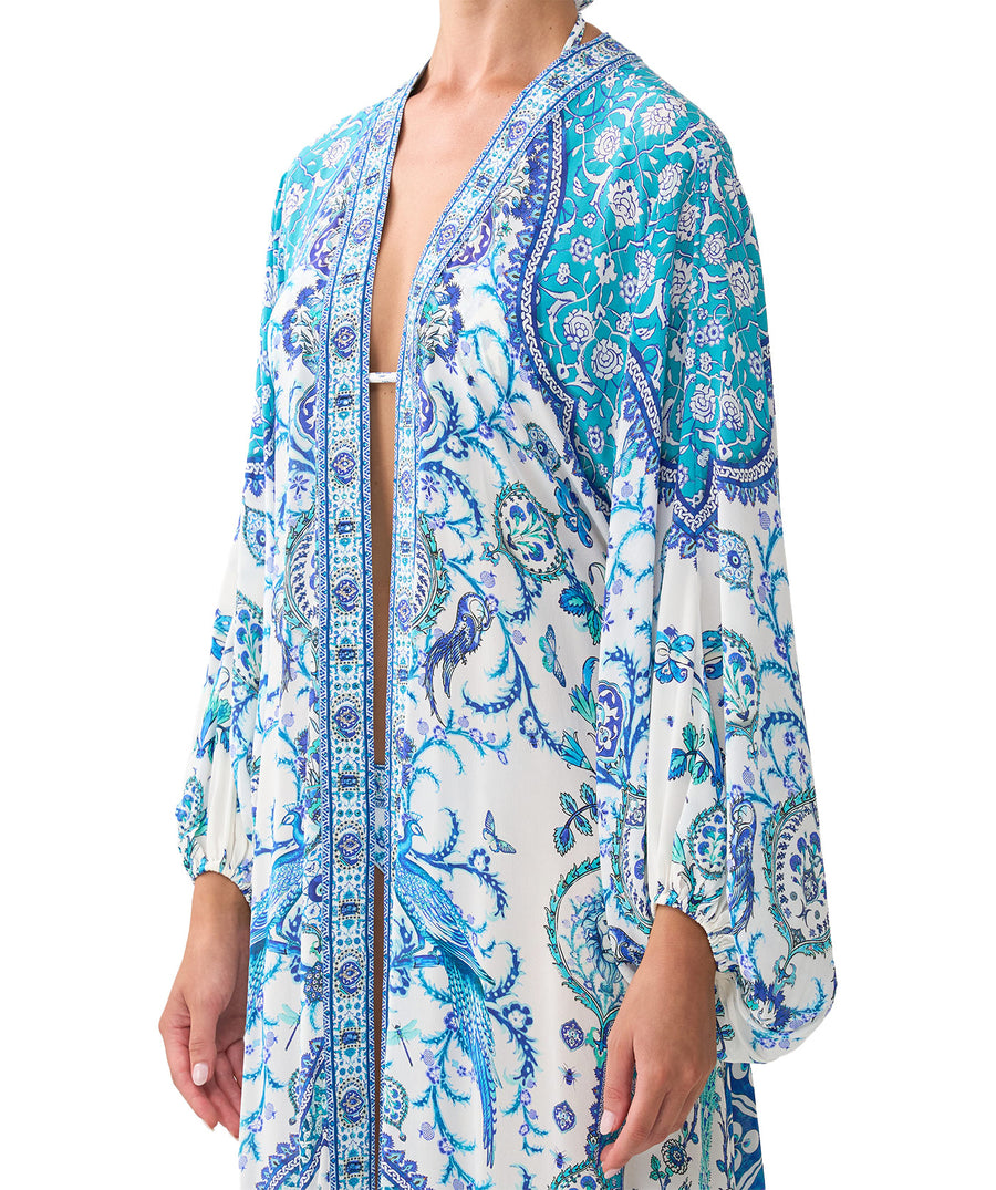 The CAMILLA Isnik Lullaby Blouson Sleeve Layer 00037270 features flowy sleeves, vibrant prints, and crystal details—perfect for luxe, effortless layering.