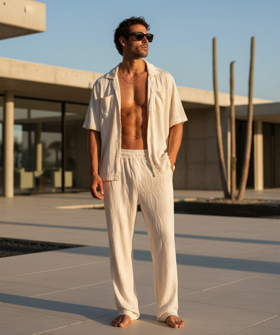 A comfy wave-textured matching set featuring a relaxed camp-collar shirt and elastic-waist pants. Ideal for warm weather, vacations, lounging, or everyday resort vibes.